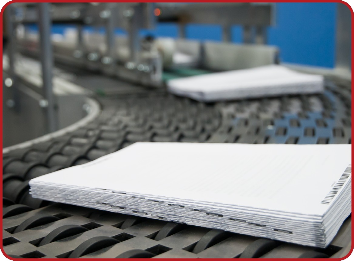 Stacks of mail on a production conveyor